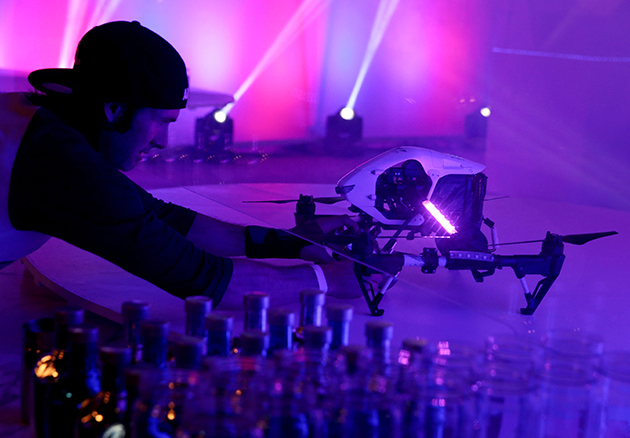 LOS ANGELES, CA - OCTOBER 23:  Drone bartenders mix cocktails at Absolut Electrik House, an epic house party transformed by the energy of its guests in celebration of new limited edition Absolut Electrik bottle, on October 23, 2015 in Los Angeles, California.  (Photo by Todd Williamson/Getty Images for Absolut)