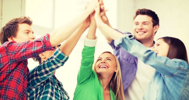 happy students giving high five at school